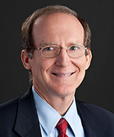Portrait and action shots of Dr. Lawrence D Abraham in the Department of Kinesiology and Health Education.